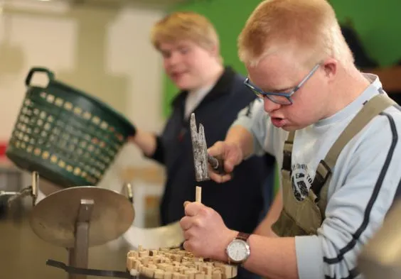 Ein junger Mann arbeitet mit einem Hammer.