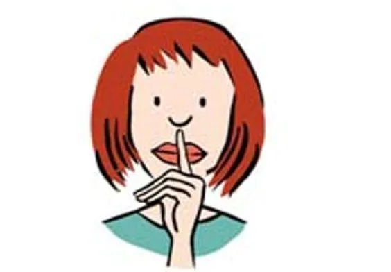 Eine Frau hält ihren Zeigefinger vor den Mund.