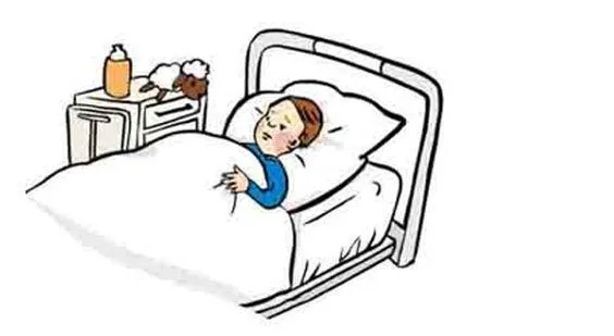 Ein Kind liegt in einem Kranken-Bett.